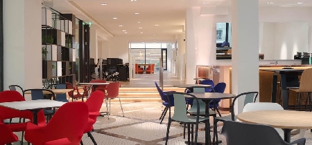 An assortment of tables, chairs and stools set up in a bright room