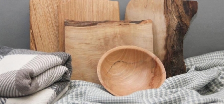 An assortment of crafted wooden cutting boards and bowls