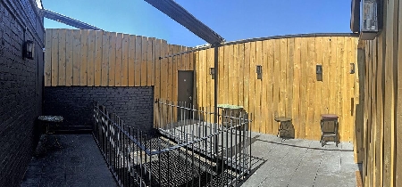 An enclosed outdoor terrace at the top of a building